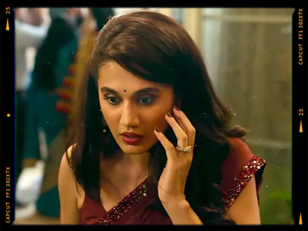 A concerned woman in a traditional saree with a bindi, looking worried while touching her face.