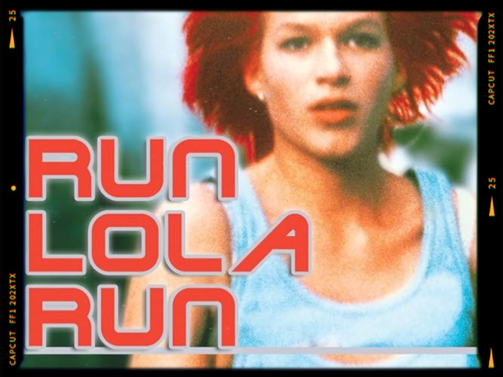 A still from the film 'Run Lola Run' featuring a young woman with short red hair, depicted in motion with a determined expression, along with the film's title in bold red letters.