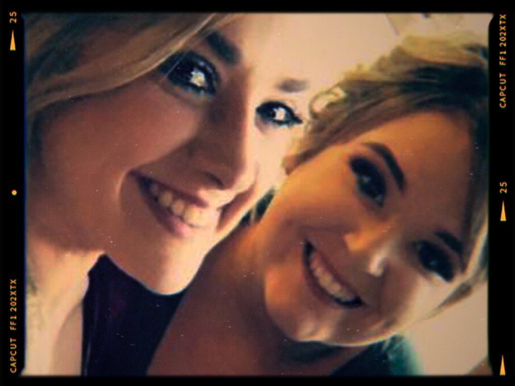 Two smiling women posing for a selfie with a soft focus background.